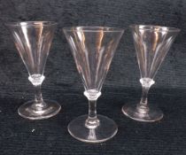 A set of three 18th Century style Wine Glasses with conical bowls and knopped stems, terminating