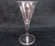 An 18th Century Conical Wine Glass with air-drop stem, terminating in a spreading circular base with