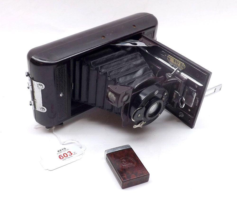 A 1930s Soho Cadet Folding Bed Camera in Bakelite case; together with a Bakelite Rolls Razor Blade