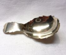 A George III Silver Caddy Spoon with short handle, the handle and bowl with serrated edges, London