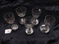 A group of five various early 19th Century Small Clear Wine Glasses of typical form, two with cut