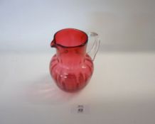 A Victorian Cranberry and Clear Glass Jug of typical form, with looped handle, 5 ½? high