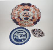 An Oriental Blue and White Circular Plate, decorated with a central Chinese River Scene; a further