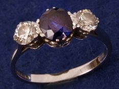 A Centre Sapphire (approx 1 ct) and two Brilliant Cut Diamond Ring (the diamonds approx 1 ct total),
