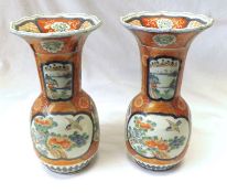 A pair of Kutani large Baluster Vases, typically decorated with panels of scenes on a
