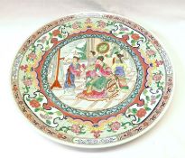 An Oriental Famille Rose Circular Plate, the centre decorated in colours with an interior scene of