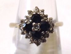 A Four Small Dark Blue Sapphire and Seventeen Small Brilliant Cut Diamond Ring, hallmarked 18ct