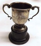 A Small Birmingham hallmarked Silver Double-Handled Trophy Cup on dark wood stand, weight approx 2