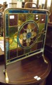 A late 19th Century Copper Framed Fire Screen with central coloured glass panel with central star,
