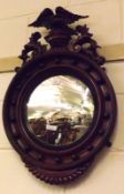 A 19th Century Mahogany Circular Convex Porthole style Mirror, with carved eagle mount, 18” wide (