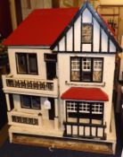 An early 20th Century Colonial style scratch built Dolls House, double opening front to reveal