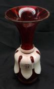 A Cranberry and White Overlaid Flared Glass Vase, raised on a round foot with ground pontil mark,