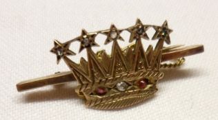 An unmarked yellow metal Naval Bar Brooch with central mounted curved crown, set with red and