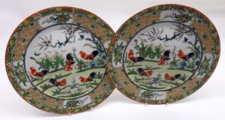 A pair of 20th Century Chinese Circular Plates, the centres painted in iron red and other colours