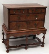 An 18th Century Walnut Chest on a later stand, crossbanded top over two short and two full width