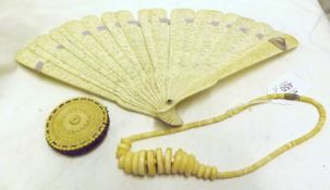 A Mixed Lot: an early 20th Century Chinese Pierced Ivory Fan a Small Ivory Pin Wheel with central