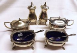 A Composite Six Piece Condiment Set comprising: two Pepper Pots, two Footed Salts with blue glass
