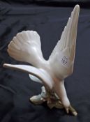 A large Lladro White Dove on foliage base, 11” high