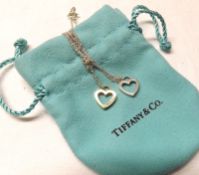 A Tiffany & Co white metal double heart Pendant with trace chain, stamped “.925”, original packaging