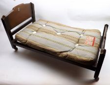 A Wood Framed Doll’s Bed with sprung base and mattress, length 25”