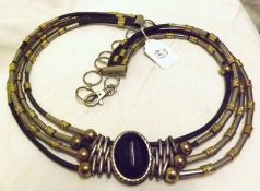 A Large Ethnic Metal Mounted and Leather Four Strand Necklace