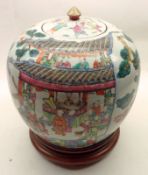 An Oriental Jar of baluster form, with plain circular cover and gilded pointed handle, the body