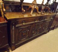 A large good quality early 20th Century Oak Sideboard in the Jacobean style with three doors and two