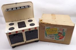 A mid-20th Century Chad Valley Toy Cooking Stove with assorted pots and pans, housed within original