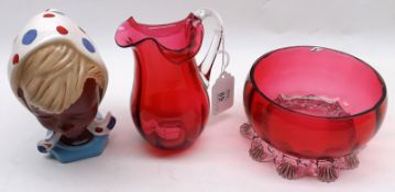 A Mixed Lot comprising: a small Cranberry Glass Jug; a further Round Cranberry Glass Bowl and a West