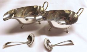 A pair of Queen Elizabeth II Sauceboats with ladles, of typical shaped oval form, swept handle,