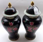 Two late 19th/early 20th Century Covered Vases, decorated with floral sprays on a black