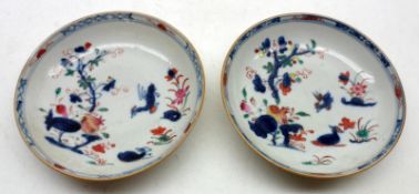 Two 18th Century Chinese Export Saucers, each painted in the centres with birds and foliage etc,