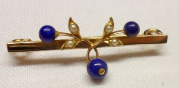An unmarked yellow metal Bar Brooch featuring a Seed Pearl and Lapis Lazuli mounted sprig with drop,