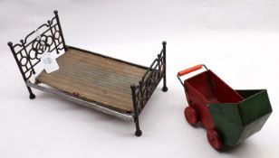 A small Iron Framed Doll’s Bed; together with a Tinplate Small Doll’s Pram (2)