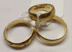 A group comprising three Gents hallmarked 9ct Gold Wedding Rings, one with engraved detail, weighing