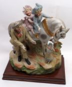 A large Continental Painted Parian Ware Figure Group of a gent and young children riding a horse,