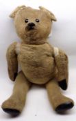 A mid-20th Century Straw and Plush-filled well-loved Teddy Bear, brown plastic eyes with stitched