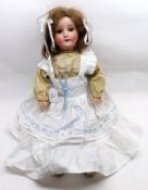 An early 20th Century Bisque Socket Head Doll, with brown weighted sleep glass eyes, painted