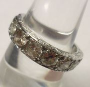 A high grade precious metal Half Hoop Ring set with seven Brilliant Cut Diamonds, estimated total