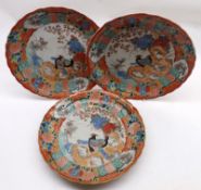 A set of three late 19th/early 20th Century Kutani Plates, decorated predominantly in iron red