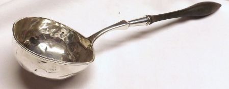 An 18th/19th Century Continental white metal Soup Ladle on turned wooden handle, total length 14”,