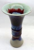 A 20th Century Oriental Trumpet Vase, decorated in lustre colours with abstract design, 10 ½” high