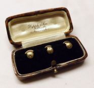 A cased set of three yellow metal Dress Studs, stamped “9ct” (minor defects to each) – Dipple & Son,