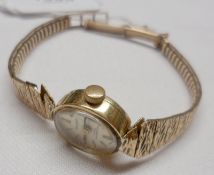 A Ladies hallmarked 9ct Gold Cased “Excalibur” Wristwatch, mounted on an integral burnished 9ct Gold