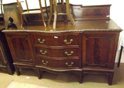 A large Edwardian Mahogany Serpentine Front Sideboard, with three central drawers and two cupboards,