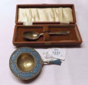 A Mixed Lot comprising: a Sterling Silver and Coloured Enamelled Tea Strainer; and a further