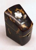 A Small Victorian Wedge-shaped Tortoiseshell Box with hinged lid inlaid with mother-of-pearl flower,