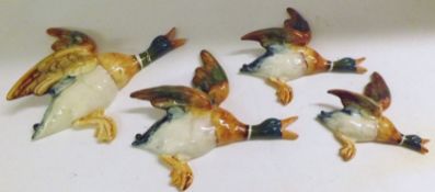 A set of four Beswick Flying Mallard Wall Plaques, Numbered 596-1, 2, 3 and 4 (largest two are