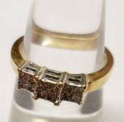 A hallmarked 14ct Gold Ring, set with three square panels each of four Princess Cut Diamonds