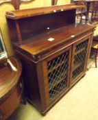A George IV Rosewood Chiffonier, single shelf to back, two doors with meshed centres, raised on